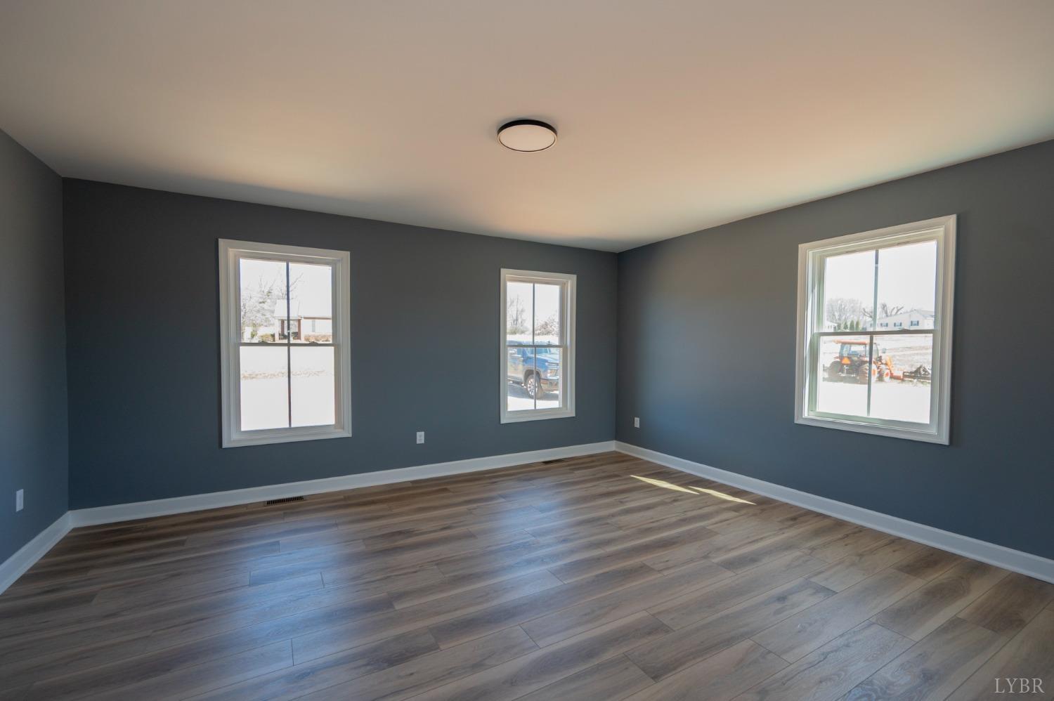 2199 Cedar Gate Road Madison Heights, VA 24572 - Photo 15 of 54 a view of an empty room with wooden floor and window