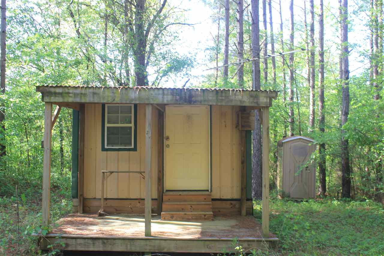 1600 Country Church Road Lamar, MS 38642 - Photo 1 of 25 a wooden house with large trees and plants