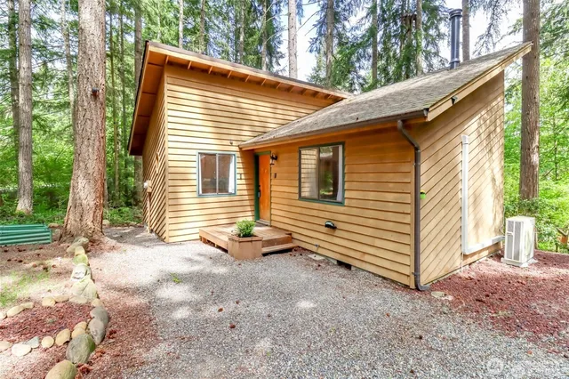a view of a house with a yard and floor to ceiling window