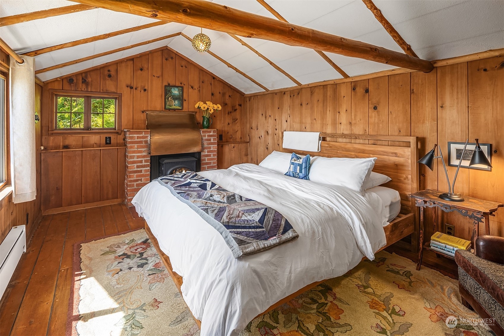 11814 Southwest Dolphin Point Road Vashon, WA 98070 - Photo 15 of 31 a bed sitting in a bedroom next to a window