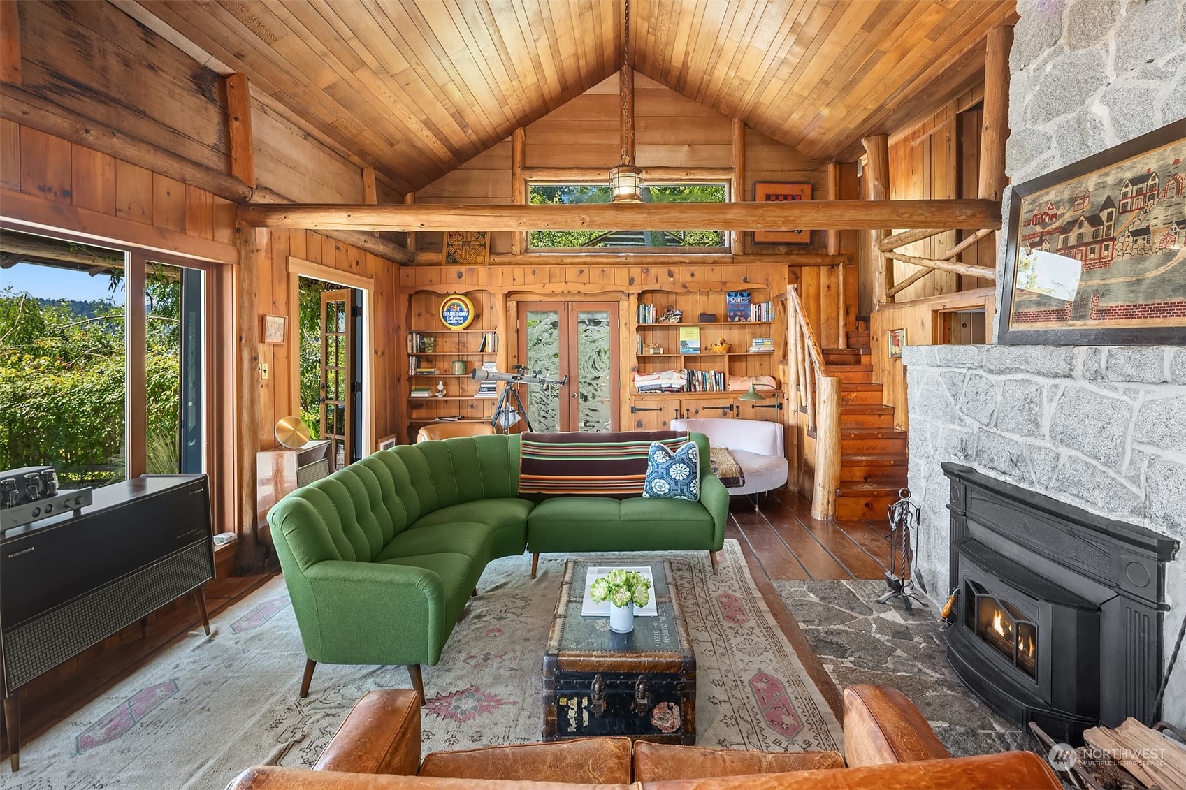 11814 Southwest Dolphin Point Road Vashon, WA 98070 - Photo 6 of 31 a living room with furniture a fireplace and a table