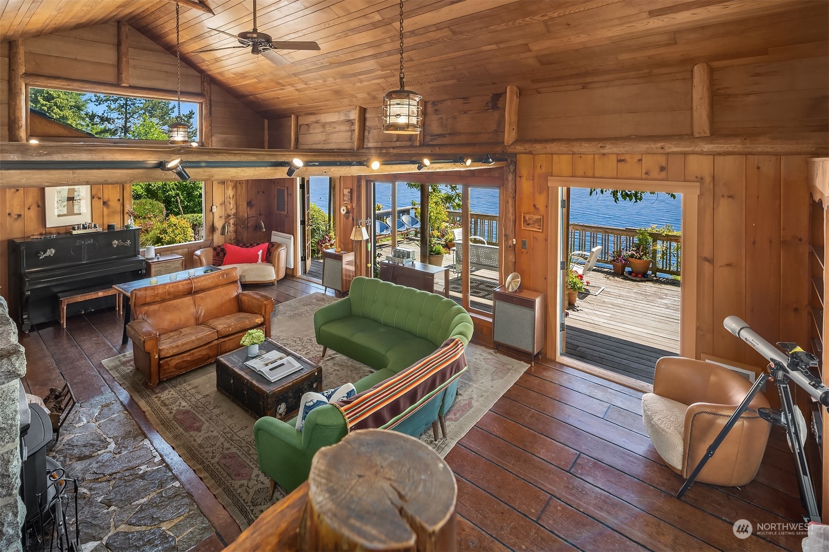 11814 Southwest Dolphin Point Road Vashon, WA 98070 - Photo 9 of 31 a living room with patio furniture and a fireplace