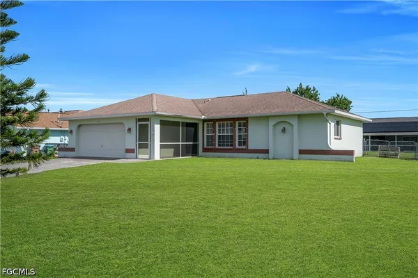 a front view of a house with a garden
