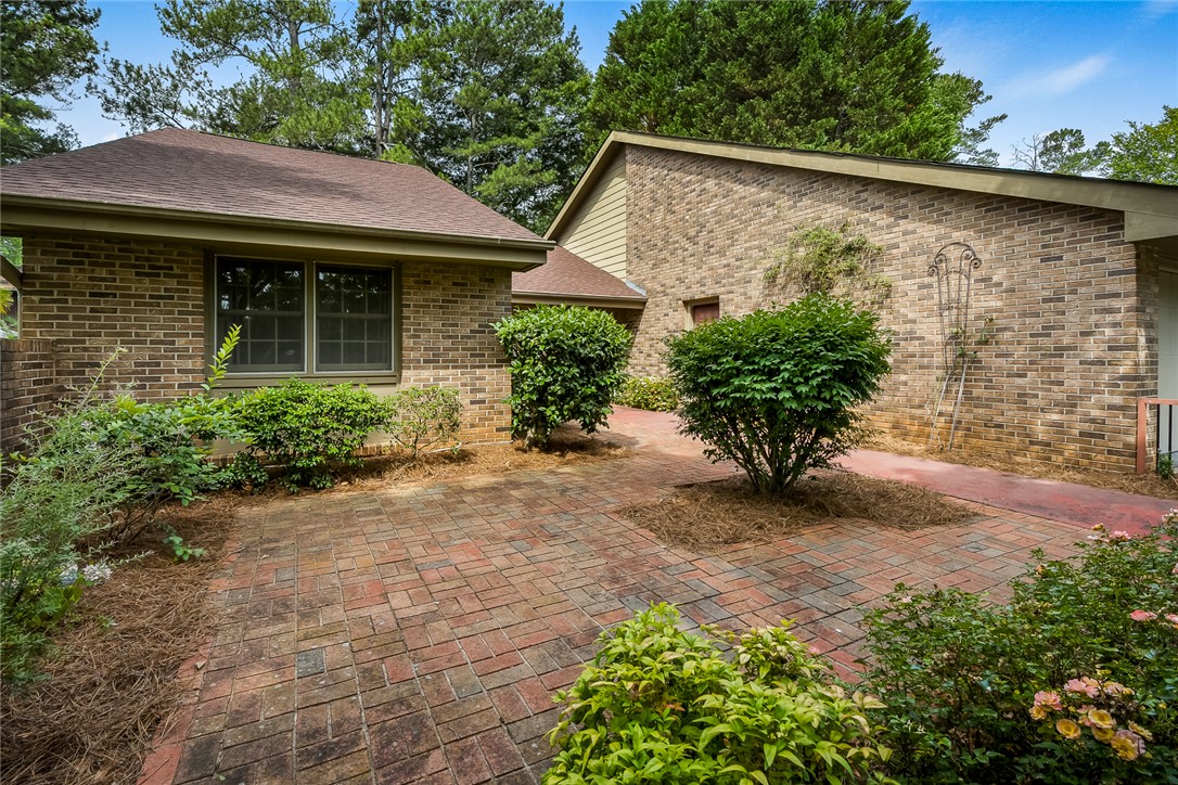 34 Hickory Way Clemson, SC 29631 - Photo 5 of 39 A charming brick exterior with lush landscaping and a welcoming paver patio.