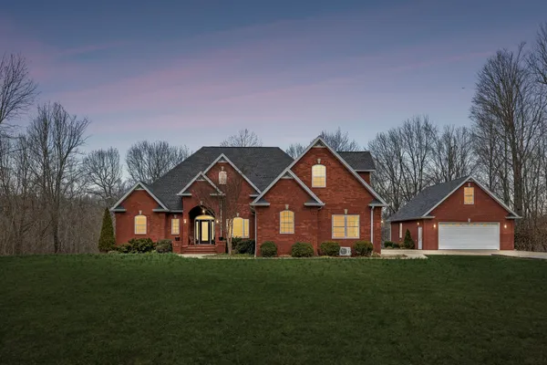 a front view of a house with a yard and garage