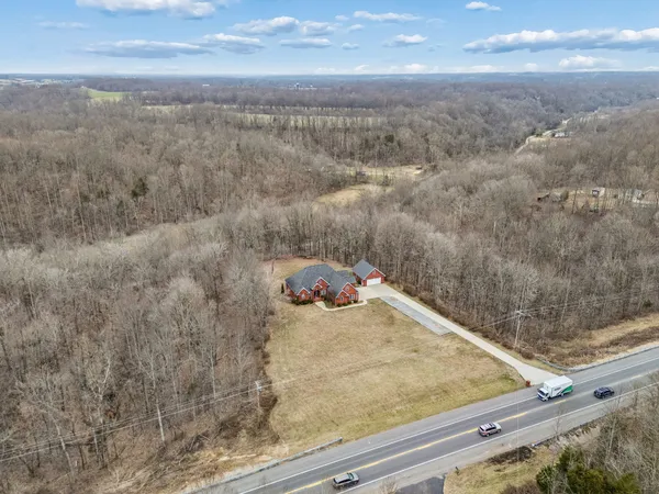 a kitchen with granite countertop a sink a counter top space stainless steel appliances and cabinets
