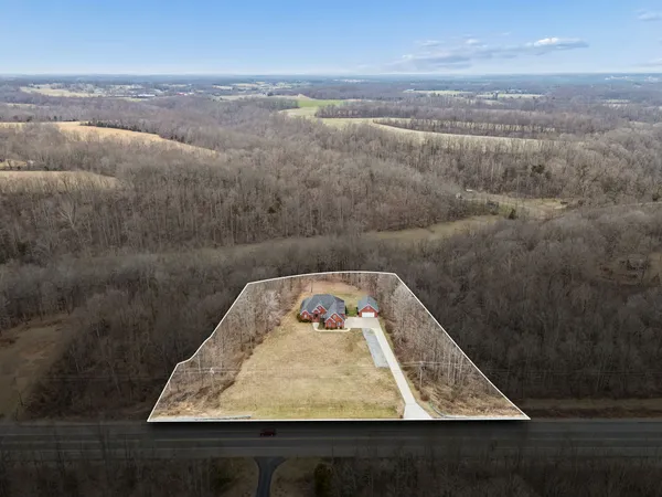 a kitchen with stainless steel appliances granite countertop a sink a stove and a wooden cabinets