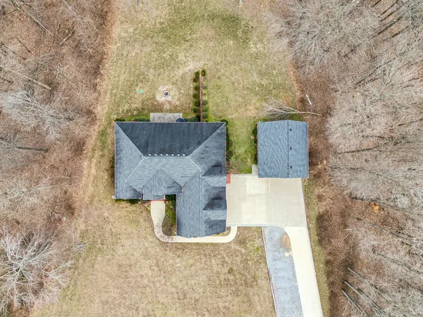 a bathroom with a granite countertop sink and a bathtub