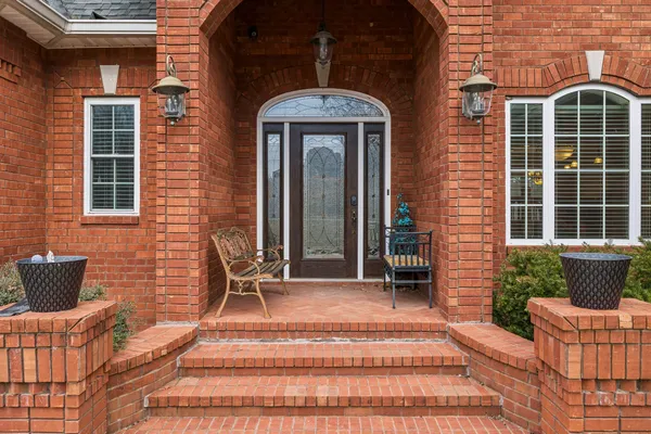 a front view of a house with yard and trees