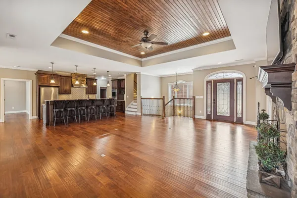 a view of a room with wooden floor windows and a chandelier