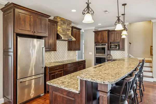 an empty room with wooden floor ceiling fan and windows
