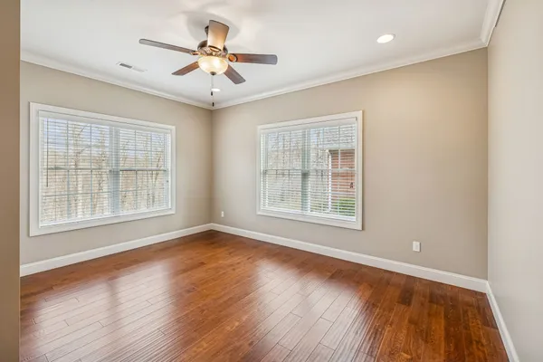 a bathroom with a granite countertop sink toilet and mirror