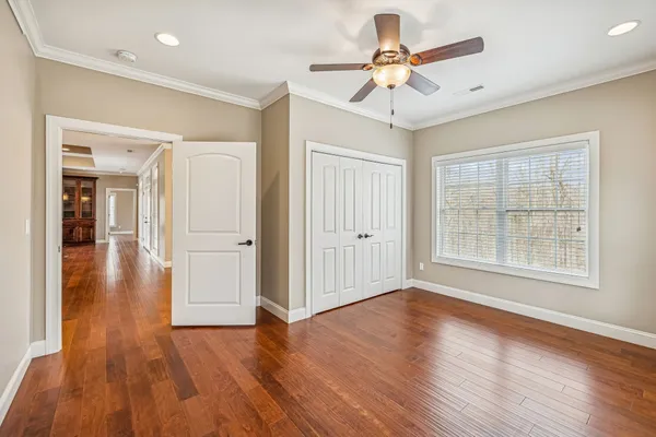 a bathroom with a granite countertop sink toilet and mirror