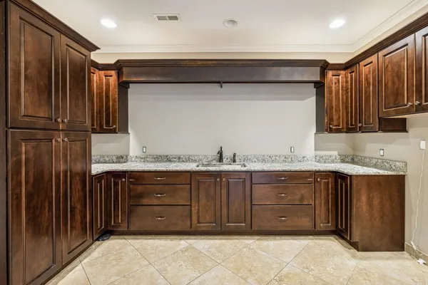 an empty room with wooden floor and ceiling fan