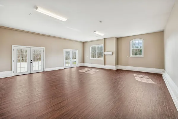 a view of a room with wooden floors and ceiling fan