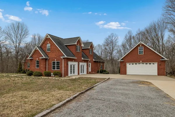 a front view of house with yard and trees