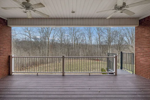 a view of a livingroom with furniture wooden floor and a floor to ceiling window