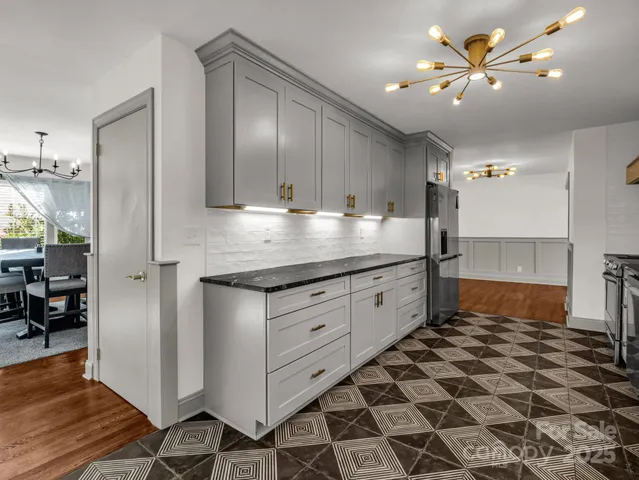 a kitchen with a sink a refrigerator and cabinets