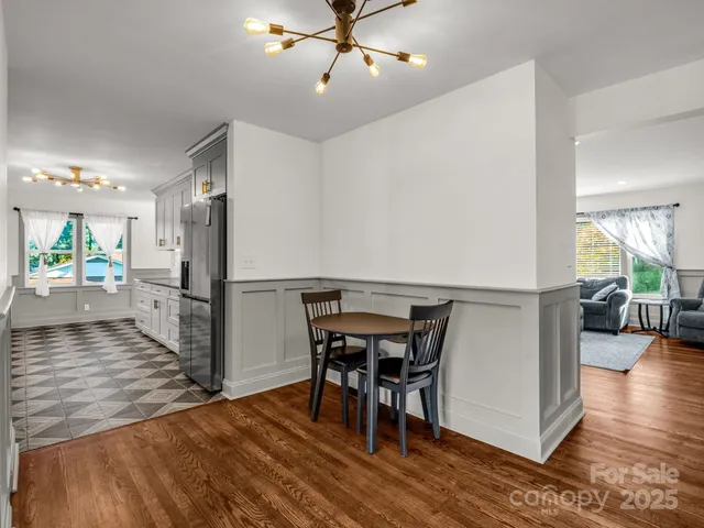 a view of a dining room with furniture and a wooden floor