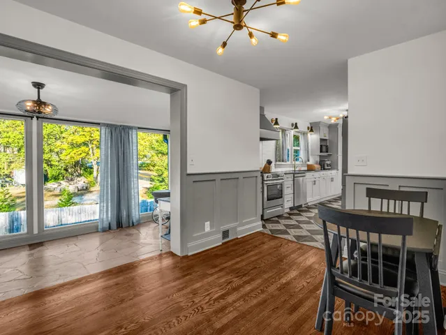 a view of a livingroom with furniture window wooden floor and front door