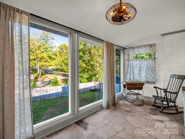 a view of a room that has a bed and a chair in it