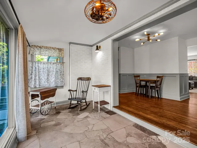 a view of a dining room with furniture and a chandelier