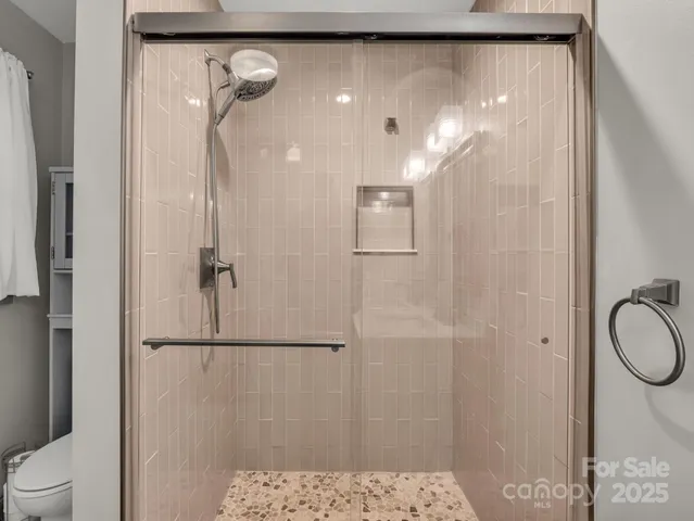 a bathroom with a shower and a toilet