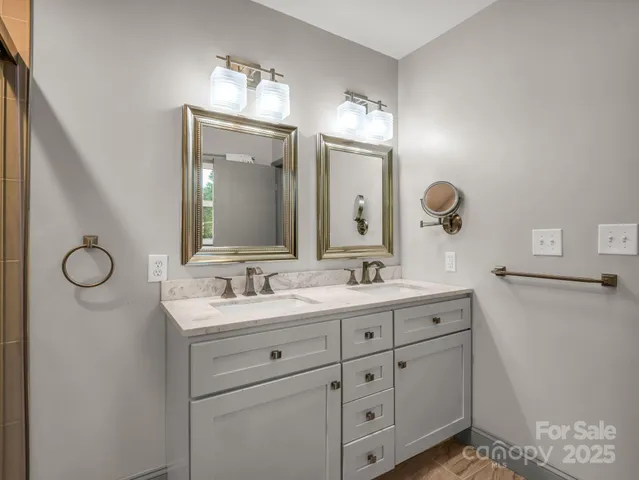 a bathroom with a double vanity sink and mirror
