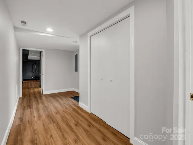 a view of an empty room with wooden floor