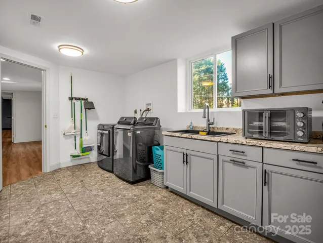a kitchen with a refrigerator and a stove top oven