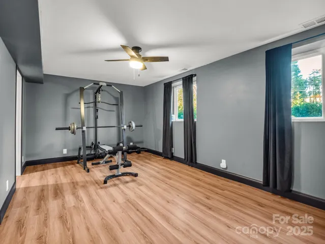 a view of a room with gym equipment and a large window