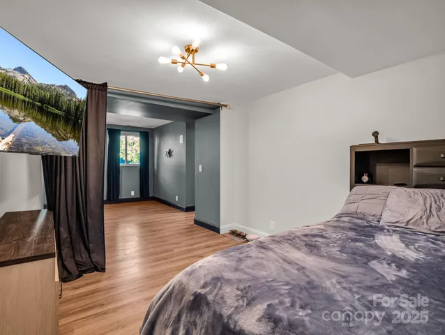 a bedroom with a bed and a mirror on dresser