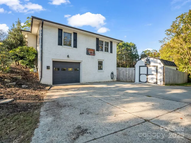 a view of a house with a yard and garage
