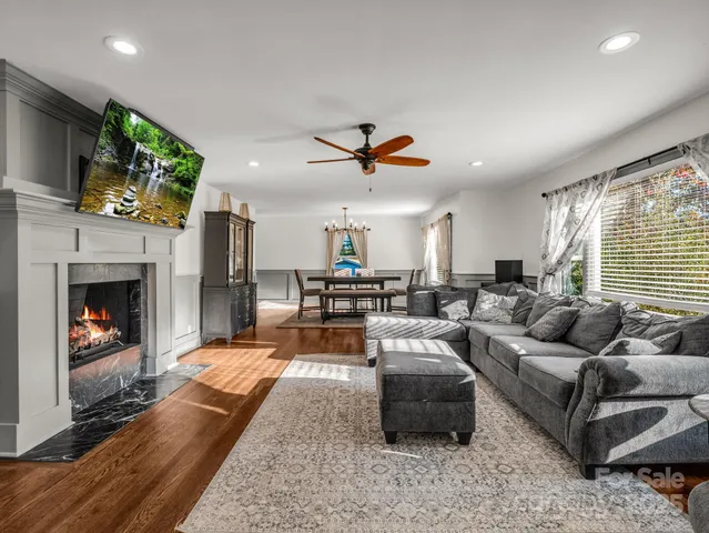 a living room with furniture fireplace and a flat screen tv