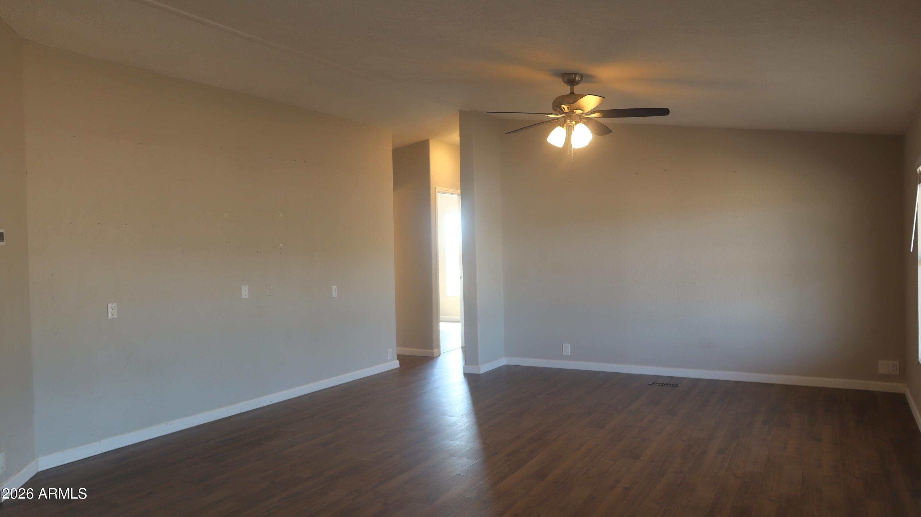 20163 North Sage Street Maricopa, AZ 85139 - Photo 12 of 54 a view of empty room with wooden floor