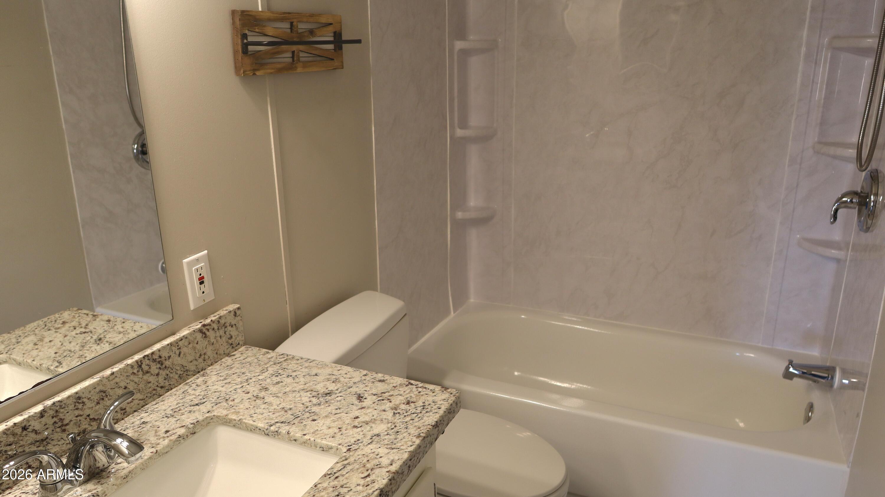 20163 North Sage Street Maricopa, AZ 85139 - Photo 13 of 54 a bathroom with a granite countertop sink toilet and shower