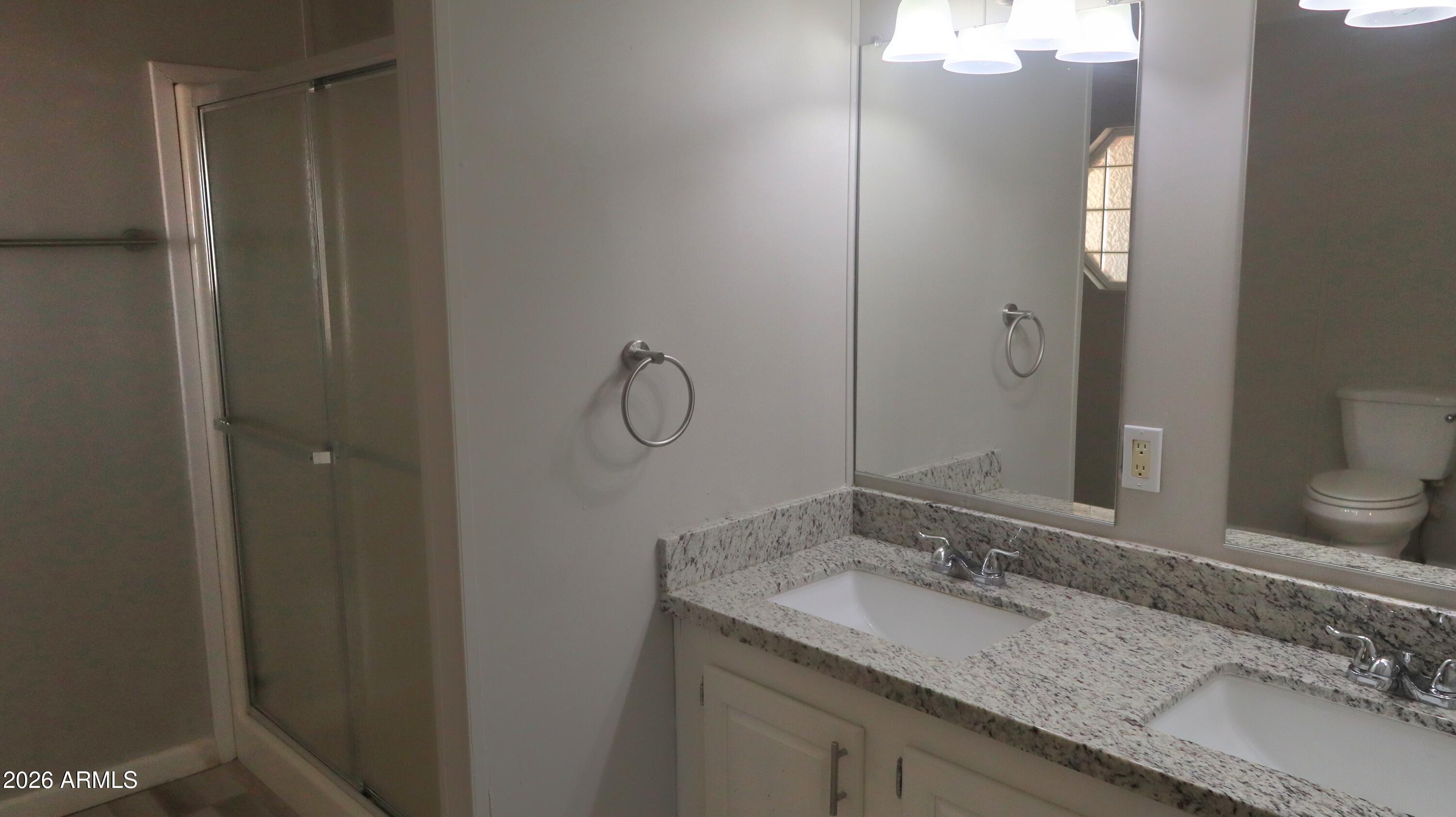 20163 North Sage Street Maricopa, AZ 85139 - Photo 17 of 54 a bathroom with a granite countertop sink and a mirror