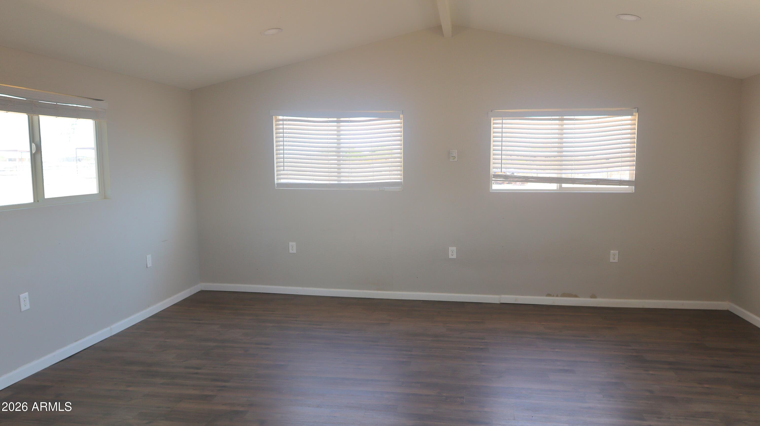 20163 North Sage Street Maricopa, AZ 85139 - Photo 28 of 54 an empty room with wooden floor and windows