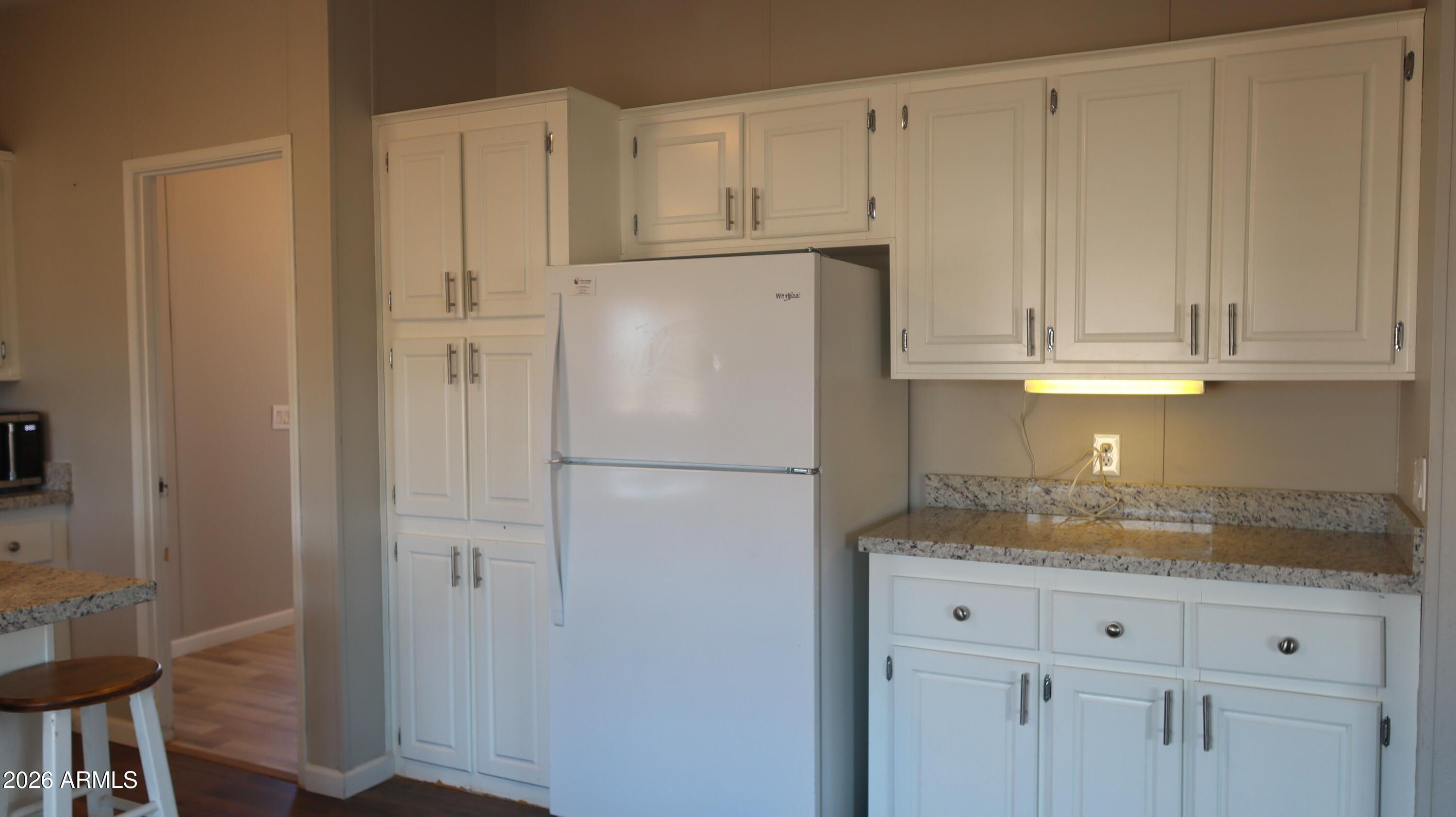 20163 North Sage Street Maricopa, AZ 85139 - Photo 8 of 54 a white refrigerator freezer sitting inside of a kitchen