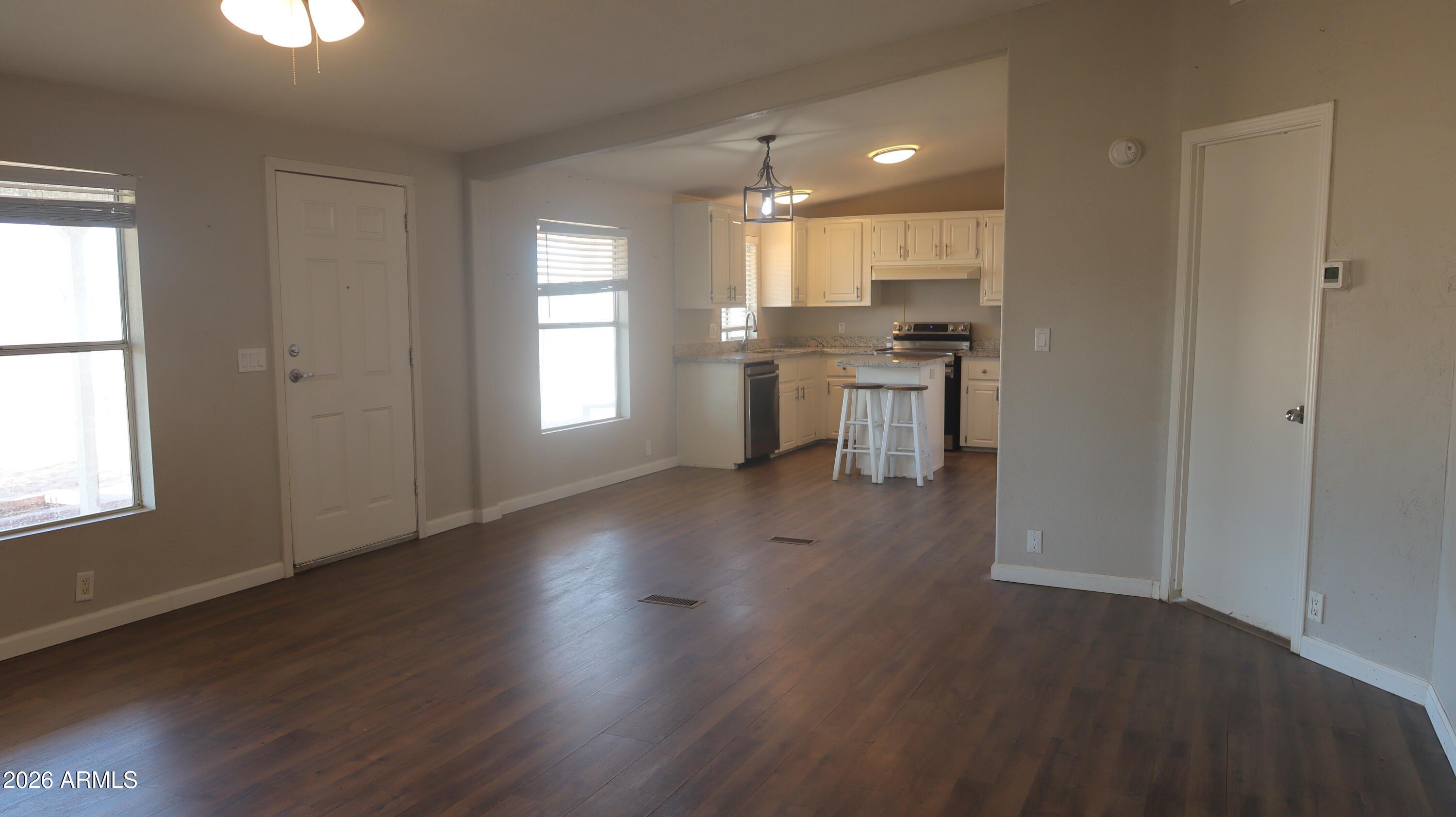 20163 North Sage Street Maricopa, AZ 85139 - Photo 9 of 54 a view of kitchen with wooden floor and electronic appliances