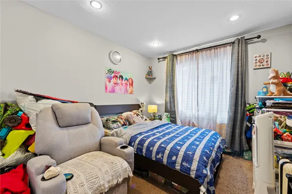 a bedroom with two beds and a window