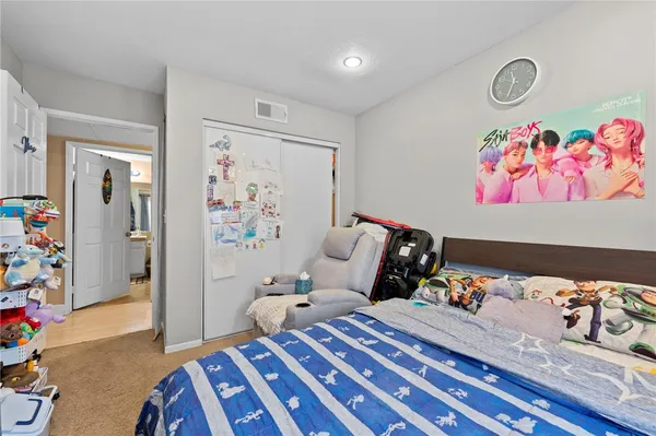 a bedroom with bed and wooden floor