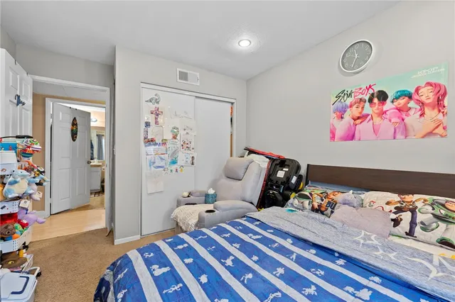 a bedroom with bed and wooden floor