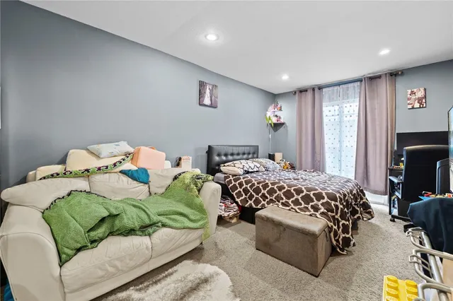 a bedroom with a bed and a couch