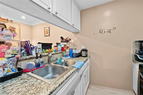 a kitchen with a sink and a stove top oven