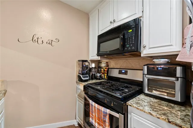 a kitchen with a stove and a microwave