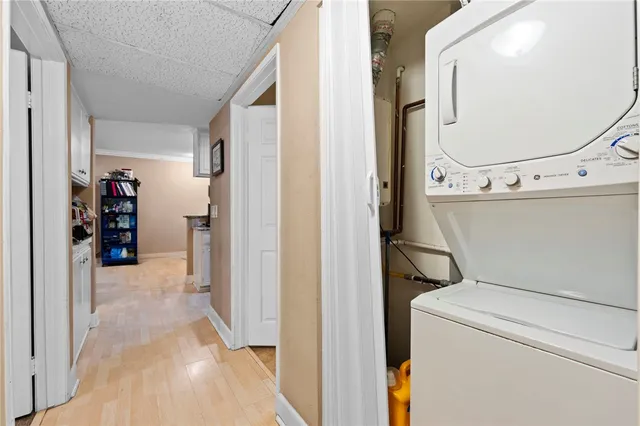 hallway with wooden floor and cabinets