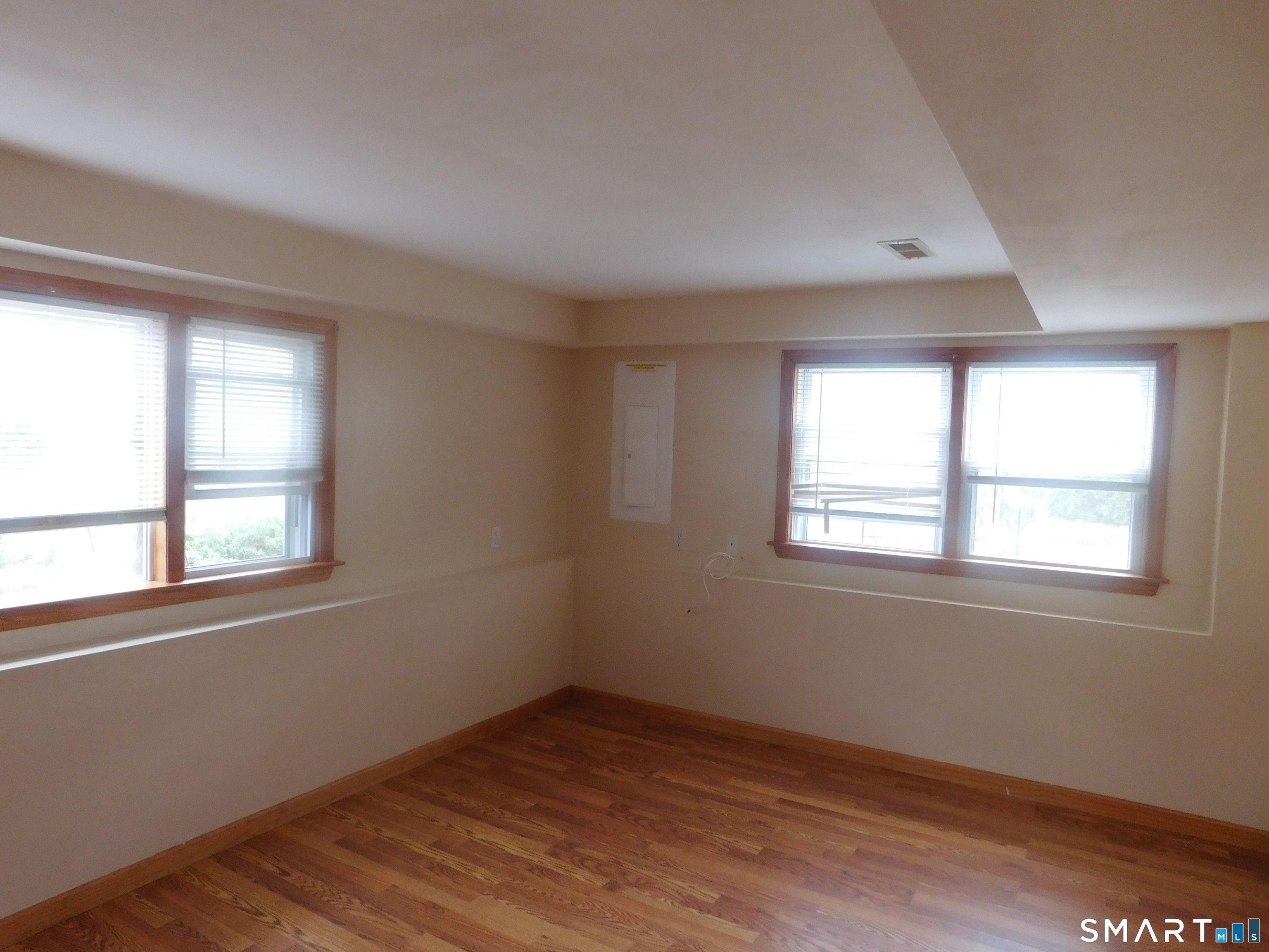6 Daybreak Lane, Unit STUDIO Shelton, CT 06484 - Photo 2 of 7 an empty room with wooden floor and windows