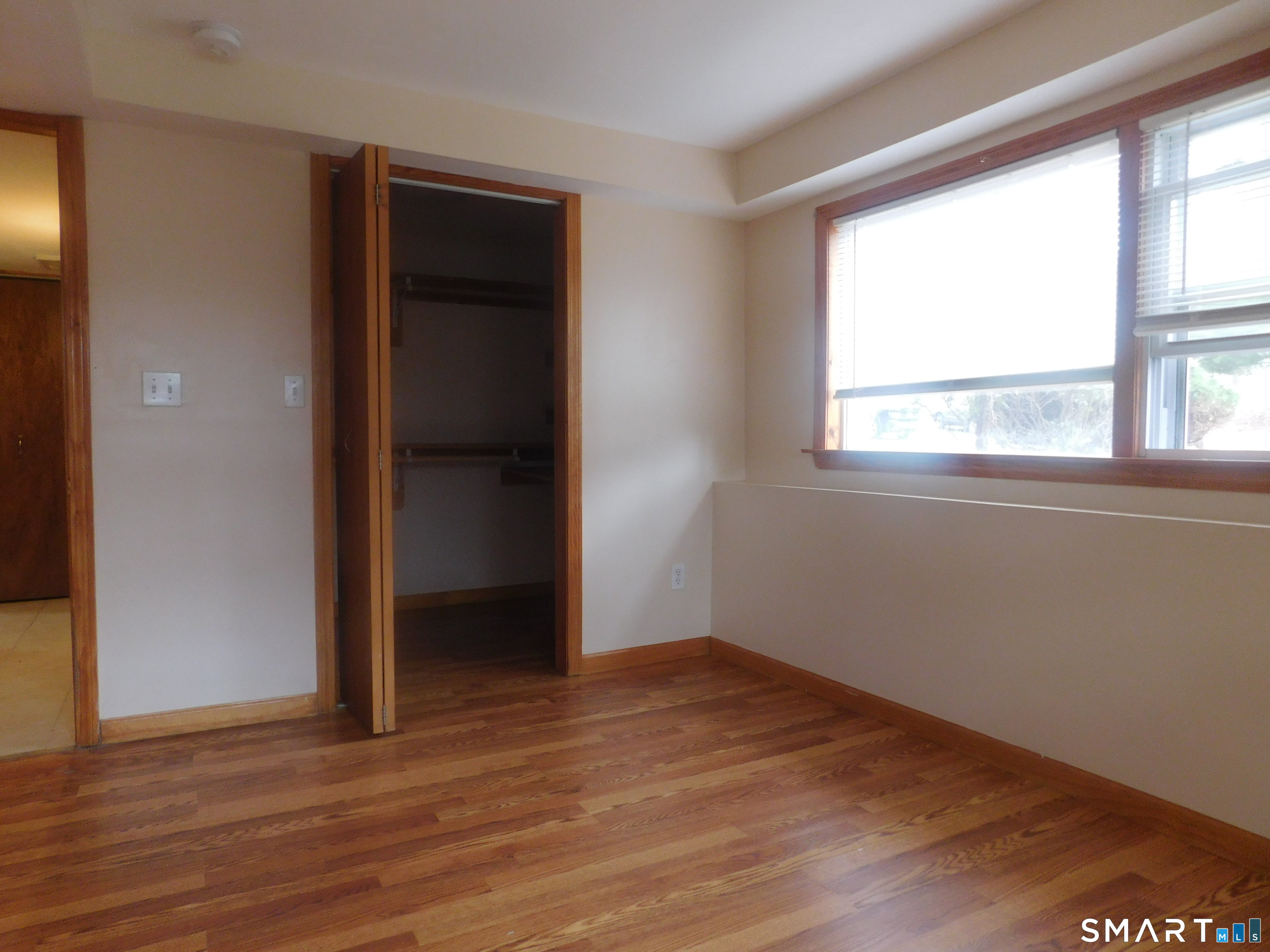 6 Daybreak Lane, Unit STUDIO Shelton, CT 06484 - Photo 3 of 7 an empty room with wooden floor and windows