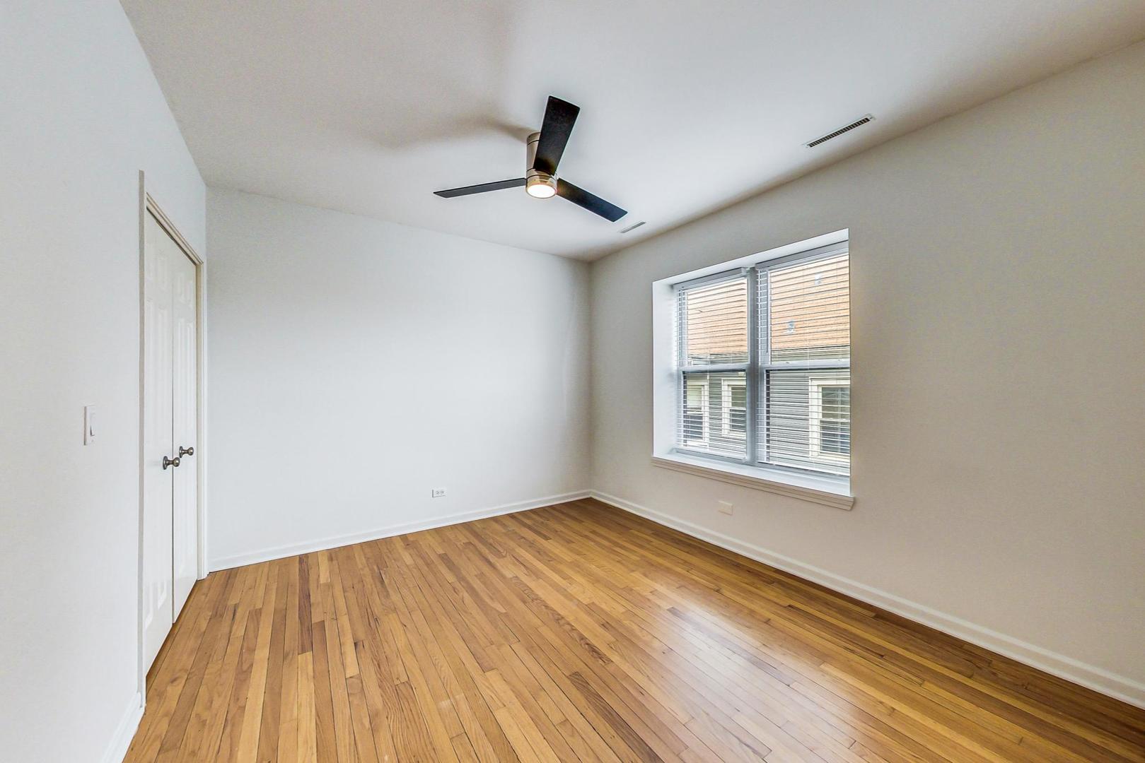 4017 North Troy Street, Unit 2W Chicago, IL 60618 - Photo 11 of 18 a view of empty room with wooden floor and fan